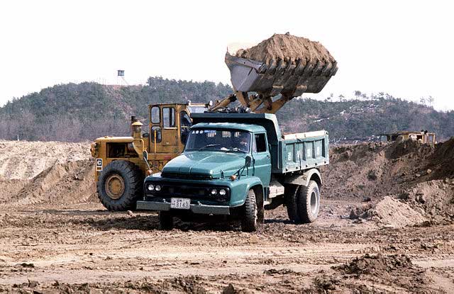 Flatbed truck being loaded up with waste and debris